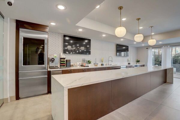 Aspire at Echelon apartments great room with community kitchen and TVs.