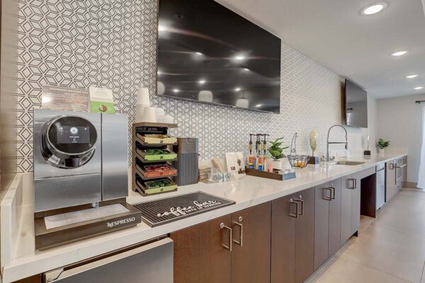 Aspire at Echelon apartments great room with coffee bar and TVs.