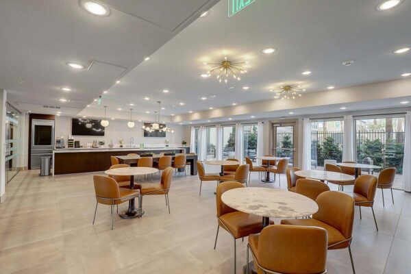 Aspire at Echelon apartments great room with dining tables and community kitchen.