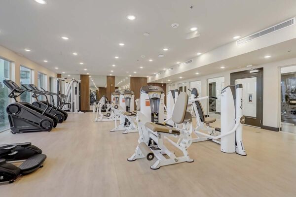 Aspire at Redwood apartments fitness center with cardio and weight machines.