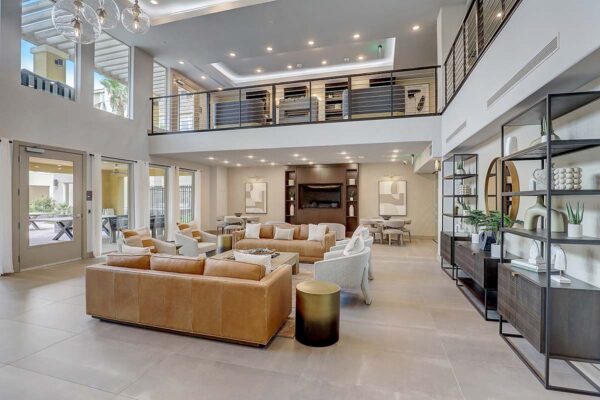 Aspire at Echelon apartments social club with plush seating, shelves with decor, and mezzanine.