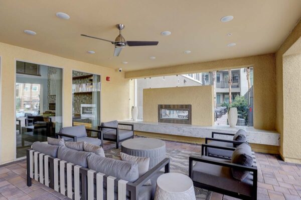 Aspire at Echelon apartments outdoor lounge with plush seating and fireplace.