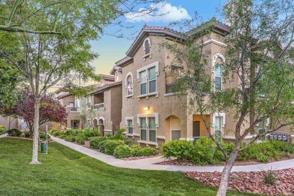 Altessa apartments with lush landscaping, large balconies, and concrete pathways.