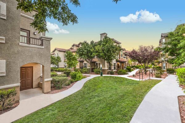 Altessa apartments with lush landscaping, large balconies, and concrete pathways.