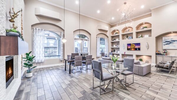 Lounge with tile floor, plush seating, TV, and large windows.