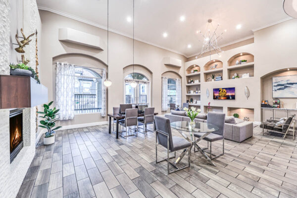 Lounge with tile floor, plush seating, TV, and large windows.
