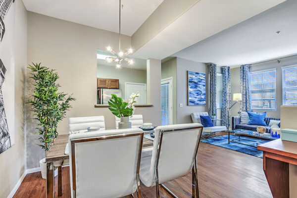 Living area with plush living room, sleek dining area, and modern kitchen.