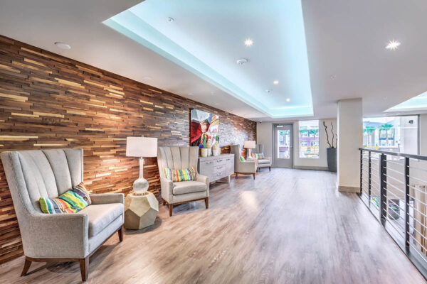 Mezzanine level with plush chairs, eclectic decor, and door to rooftop patio.