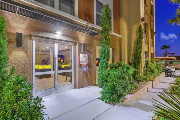 Office entrance with lush landscaping and bright walkways.