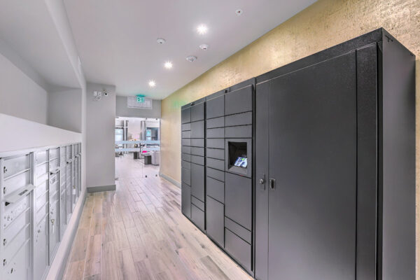 Mail room with grey mailboxes and large parcel lockers.