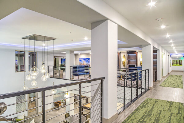 Clubroom mezzanine with railing overlooking clubroom.