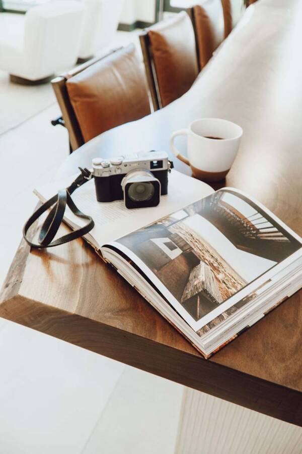 Live edge wood table with photo book and camera.