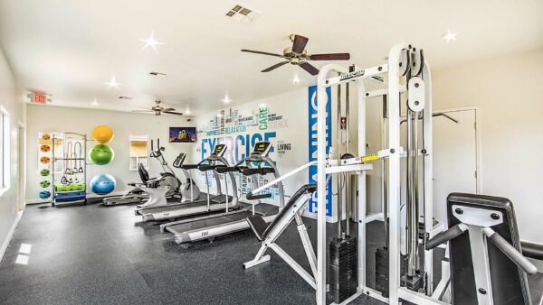 Fitness center with cardio machines and weight equipment.
