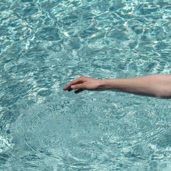 A resident enjoying the resort-style pool at Aspire at Echelon.
