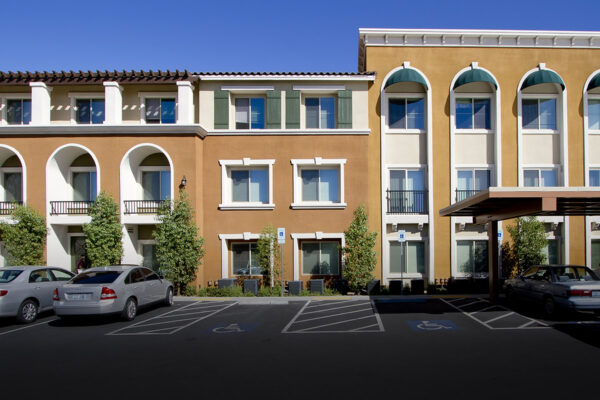 Minuet apartments with classic architecture, lush landscaping, and ample covered parking.
