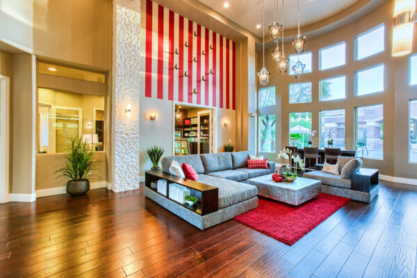 Clubhouse with vaulted ceilings, plush seating, snack bar, and shelves with decor.
