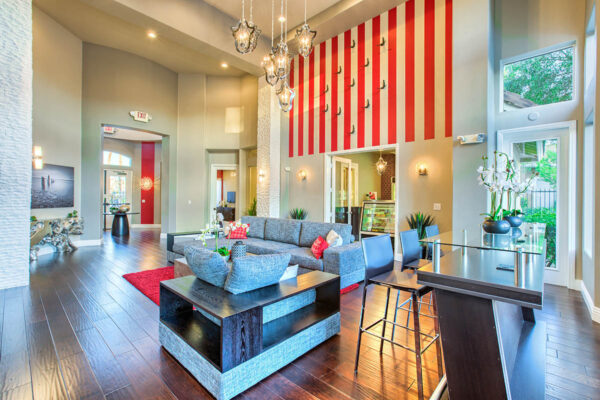 Clubhouse with vaulted ceilings, plush seating, snack bar, and shelves with decor.