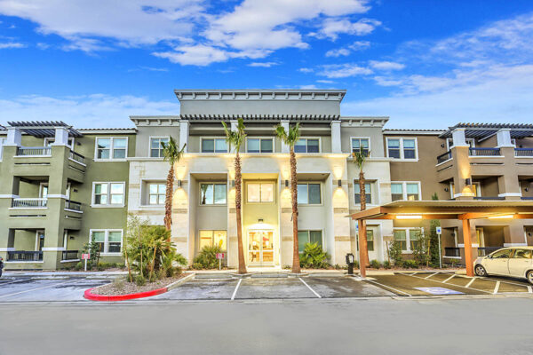 Radiance at Grand Canyon apartments with tall palms and ample covered parking.