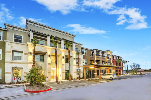 Radiance at Grand Canyon apartments with tall palms and ample covered parking.