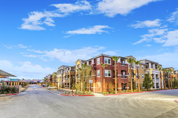 Radiance at Grand Canyon apartments with tall palms and ample covered parking.