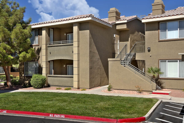 San Croix apartments with lush green lawns, rocky landscaping, and ample parking.