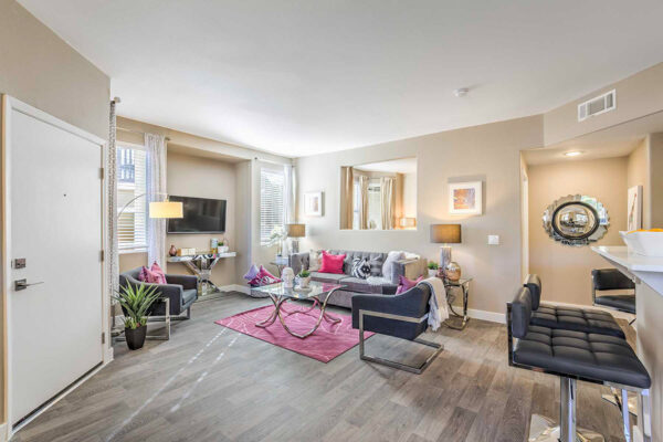 Summerlin apartment living room with open floorplan, couch, and kitchen seating area