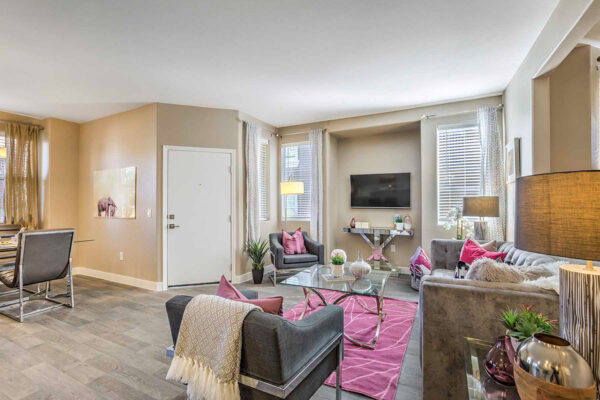 cozy one bedroom apartment in Summerlin with couch, mounted TV, and plush rug