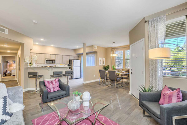 Living area with wood floors, modern kitchen and dining area, and comfortable seating area.