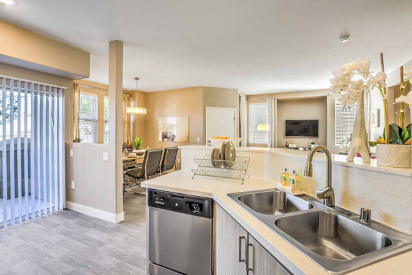 Summerlin apartmnet kitchen with stainless steel appliances, long counter and patio access