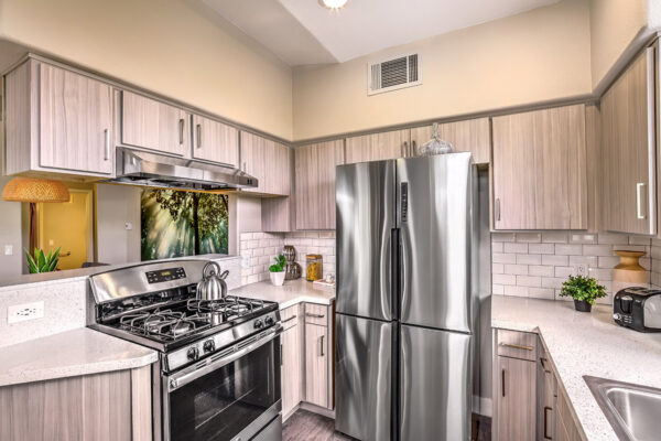 kitchen in apartment in summerlin las vegas, with stainless steel appliances, gas range and plank wood flooring