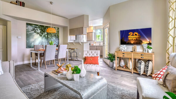 Apartment living area with modern kitchen, elegant dining room, and comfortable living room.