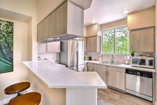 Summerlin apartment kitchen with kitchen island, stainless steel appliances and large window