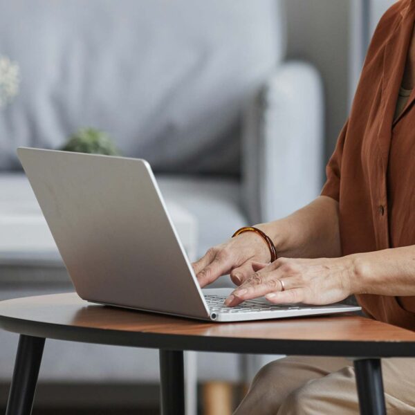 Person working on laptop computer at home.