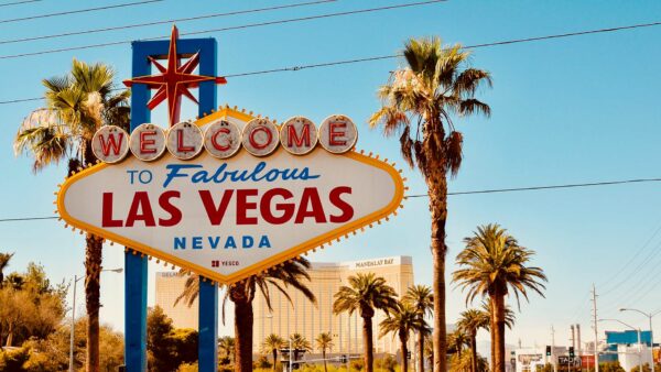 Neon sign reading Welcome to Fabulous Las Vegas flanked by palm trees.