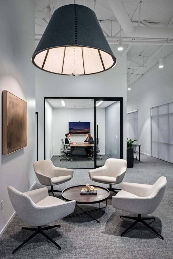 Office space with chairs, table, and small conference room.