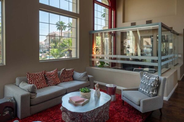 Arzano apartments lounge with plush seating and large windows.