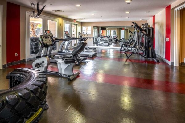 Arzano apartments fitness center with cardio machines and weight equipment.