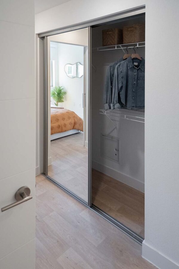 Arzano apartment hallway with mirror closet door.