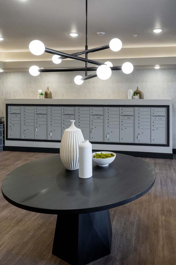 Arzano apartments mail room with mail boxes and elegant decor.