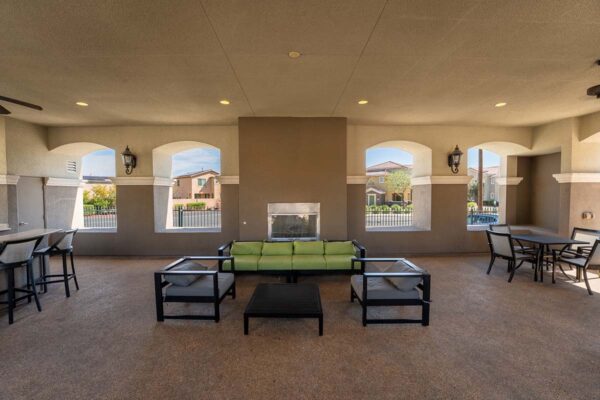 Arzano apartments outdoor gazebo with plush seating, fireplace, and dining table.