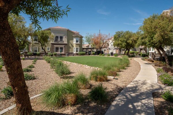 Arzano apartments courtyard with lush landscaping and trees.